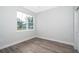 Simple bedroom with grey flooring and a large window at 2706 Alamo Dr, Orlando, FL 32805