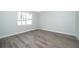 Spacious bedroom featuring wood-look floors and a large window at 2706 Alamo Dr, Orlando, FL 32805