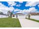 Newly constructed home with a modern facade, driveway, and grassy lawn at 2706 Alamo Dr, Orlando, FL 32805