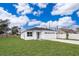 New construction home with a white exterior, gray door and attached garage at 2706 Alamo Dr, Orlando, FL 32805