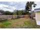 Large backyard with wooden fence and palm trees at 2845 Oak Lea Dr, South Daytona, FL 32119