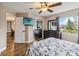 Cozy bedroom with hardwood floors and mirrored closet doors at 3662 Mohawk Dr, Mount Dora, FL 32757