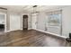 Spacious living room featuring hardwood floors, a modern light fixture, and neutral decor at 3662 Mohawk Dr, Mount Dora, FL 32757