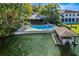 Aerial of home, pool, boat dock, and lush landscaping at 451 Northwind Rd, Maitland, FL 32751