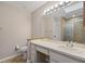 Clean bathroom with a sink, toilet and large mirror at 466 W Par St # 466, Orlando, FL 32804