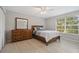 Light-filled bedroom with wood flooring, dresser, and a double bed at 466 W Par St # 466, Orlando, FL 32804