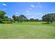 Expansive green golf course with trees and a clear blue sky at 466 W Par St # 466, Orlando, FL 32804