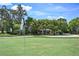 View of a house from a golf course with trees and a flag at 466 W Par St # 466, Orlando, FL 32804