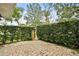 Private brick patio with lush green hedges for added privacy at 466 W Par St # 466, Orlando, FL 32804