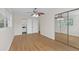 Spacious bedroom with hardwood floors and mirrored closet doors at 4862 Indialantic Dr, Orlando, FL 32808