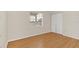 Well-lit bedroom with wood floors and double closet at 4862 Indialantic Dr, Orlando, FL 32808