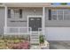 Gray house with dark double doors and white railing at 4862 Indialantic Dr, Orlando, FL 32808