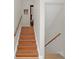 Wooden staircase with a wooden handrail at 4862 Indialantic Dr, Orlando, FL 32808