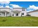 Large backyard with covered patio and grassy area at 5302 Royal Point Ave, Kissimmee, FL 34746