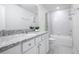 Bathroom with granite countertop, tub, shower, and white cabinets at 5302 Royal Point Ave, Kissimmee, FL 34746