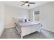 Bedroom with a white sleigh bed, nightstand, and ceiling fan at 5302 Royal Point Ave, Kissimmee, FL 34746