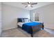 Bedroom with dark-wood bed, ceiling fan, and window at 5302 Royal Point Ave, Kissimmee, FL 34746