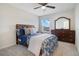 Bedroom with a wooden bed frame, dresser and ceiling fan at 5302 Royal Point Ave, Kissimmee, FL 34746