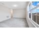 Bright bedroom featuring ample natural light and grey carpet at 5302 Royal Point Ave, Kissimmee, FL 34746