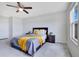 Cozy bedroom with gray bedding, nightstands, and a ceiling fan at 5302 Royal Point Ave, Kissimmee, FL 34746