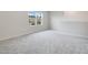 Spacious bedroom with neutral carpeting and large window at 5302 Royal Point Ave, Kissimmee, FL 34746