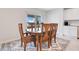 Bright dining room featuring a wood table with six chairs and access to backyard at 5302 Royal Point Ave, Kissimmee, FL 34746