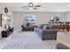 Open living room with gray sofas and a view to the dining area at 5302 Royal Point Ave, Kissimmee, FL 34746