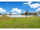 Peaceful backyard pond view with lush green grass at 5302 Royal Point Ave, Kissimmee, FL 34746