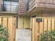 Townhome entrance with wood fence and gate at 5392 Elm Ct # 363, Orlando, FL 32811