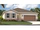 One-story home with a brown garage door and stone accents at 5513 Hanover Square Dr, St Cloud, FL 34771