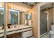 Well-lit bathroom featuring a spacious vanity, mirrored wall, and separate shower stall at 596 Albany Pl, Longwood, FL 32779