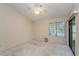 Well-lit bedroom with neutral walls, a ceiling fan, and sliding glass doors to the outdoors at 596 Albany Pl, Longwood, FL 32779