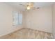 Neutral bedroom featuring a window, ceiling fan, and closet at 596 Albany Pl, Longwood, FL 32779