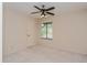 Cozy bedroom featuring a ceiling fan, natural light from the window and neutral carpeting at 596 Albany Pl, Longwood, FL 32779