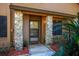 Inviting front entrance with stone pillars and tropical landscaping at 596 Albany Pl, Longwood, FL 32779