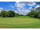 Scenic view of a lush green golf course on a sunny day, perfect for recreation at 596 Albany Pl, Longwood, FL 32779