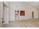 Bright living room showcasing neutral carpeting and a view into the adjacent kitchen at 596 Albany Pl, Longwood, FL 32779