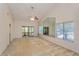 Bright living room with vaulted ceilings, a large mirror, and windows offering ample natural light at 596 Albany Pl, Longwood, FL 32779