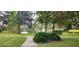 Scenic view of a pond with a fountain, framed by lush vegetation and a paved walking path at 596 Albany Pl, Longwood, FL 32779