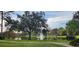 Picturesque pond with a fountain, surrounded by mature trees and lush greenery at 596 Albany Pl, Longwood, FL 32779