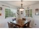 Bright dining room with a wood table and four chairs, plus large windows at 602 Iris St, Altamonte Springs, FL 32714