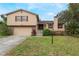 Two-story house with attached garage and landscaped yard at 602 Iris St, Altamonte Springs, FL 32714