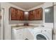 Laundry room with white cabinets, washer, dryer, and corner counter space at 602 Iris St, Altamonte Springs, FL 32714