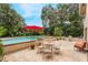 Inviting pool area with patio furniture and red umbrella at 602 Iris St, Altamonte Springs, FL 32714