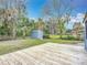 Fenced backyard with a wooden deck and storage shed at 608 Powers Ave, Port Orange, FL 32127