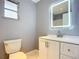 Clean bathroom with a lighted mirror and white vanity at 608 Powers Ave, Port Orange, FL 32127