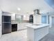 Modern kitchen with white cabinets, stainless steel appliances, and an island at 608 Powers Ave, Port Orange, FL 32127