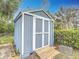 Gray storage shed with white trim and wooden ramp at 608 Powers Ave, Port Orange, FL 32127