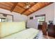 Spacious bedroom with wood ceiling and sliding door access at 628 Twin Oaks Cir, Daytona Beach, FL 32117