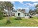 Light green house exterior with a detached workshop at 628 Twin Oaks Cir, Daytona Beach, FL 32117